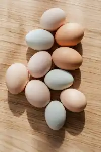 Ten eggs on a wooden table.